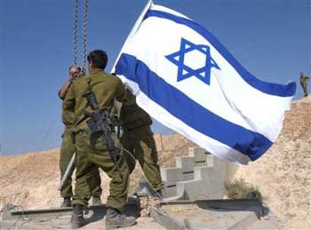 Israeli soldiers remove an Israeli flag as they dismantle an army checkpoint at the entrance of the West Bank town of Jericho, Wednesday March 16, 2005. Israel on Wednesday handed the control of Jericho to Palestinian security, Palestinian commanders said, ending a weeks-long impasse over the removal of army roadblocks and giving a fresh boost to Mideast peace-making. Jericho is the first of five West Bank town to revert back to Palestinian control in coming weeks.(AP