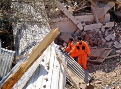 Rescuers search for survivors in the rubble of a mosque in the village of Sugozu in Sivas, a central Anatolian province some 450 kilometers, 280 miles, southeast of Ankara, Turkey, Thursday, March 17, 2005. A landslide in central Turkey buried 21 houses, and at least 17 people were reported missing. New landslides were hampering efforts to reach people feared buried under the mud. (AP Photo/Abdulkadir Ozonsoy,Anatolia) 
