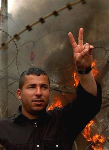 An anti-U.S. 
 Lebanese 
 protestor gestures with his hand during a demonstration near the U.S. Embassy in Aukar northeast of Beirut, Lebanon, Tuesday March 22, 2005. [AP]