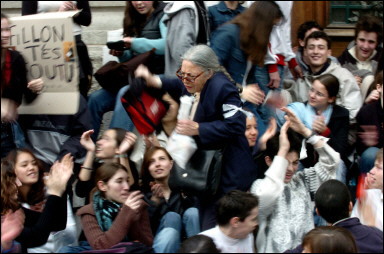 The French Senate gave the final go-ahead to a controversial education bill that has prompted angry marches by thousands of students through the streets of French towns and cities. Picture shows a teacher (C with glasses) at Edouard Herriot high school walking through a crowd of students blocking the entrance of their institution in protest against the government's education policies in Lyon(AFP/Jean-Philippe Ksiazek)