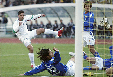 Iran's Vahid Hashemian (L) scores Iran's first goal as Japanese defenders look on during their the World Cup 2006 qualifying match in Tehran. Iran won 2-1. [AFP]