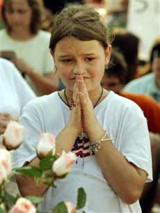 Rosie Kimball, 10, of Tampa, Fla., prays during a prayer service for Terri Schiavo, who passed away earlier in the day, Thursday, March 31, 2005,in Pinellas Park, Fla, in front of Woodisde Hospice where she was cared for. (AP P
