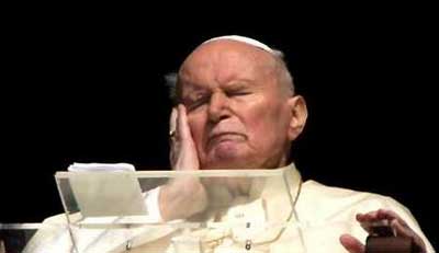Pope John Paul II touches his face as he appears from the window of his private apartment at the Vatican March 30, 2005. Pope John Paul's fragile health took a turn for the worse as he developed a very high fever caused by a urinary infection, the Vatican said. Picture taken March 30, 2005.