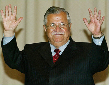 Veteran Kurdish leader Jalal Talabani raises his hands after being sworn in as Iraq's president during a meeting of the National Assembly in Baghdad. Talabani became the first non-Arab president of an Arab country.(AFP/POOL/Ceerwan Aziz)