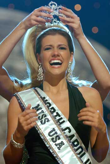 Chelsea Cooley of Charlotte, North Carolina, reacts to winning the title of Miss USA 2005 as she is crowned by Miss USA 2004 Shandi Finnessey (back) in Baltimore, Maryland April 11, 2005. [Reuters]