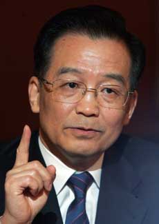 Chinese Premier Wen Jiabao gestures during a news conference in New Delhi April 12, 2005. Wen winds up a visit to India on Tuesday having made progress on a border row, boosted trade and energy cooperation, and with a vow by the world's fastest prowing economies to be partners rather than rivals.