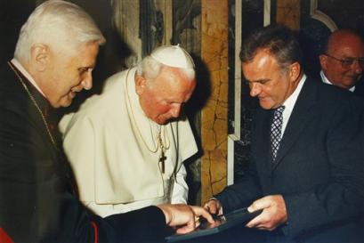 German Cardinal Joseph Ratzinger, left, shows documents to Pope John Paul II center, as Hubert Gschwendtner, mayor of Marktl, southern Germany, Ratzinger's hometown, looks on in Marktl, in this undated file picture. Cardinal Joseph Ratzinger of Germany, a longtime guardian of doctrinal orthodoxy, was elected the new pope Tuesday, April 19, 2005 evening in the first conclave of the new millennium. He chose the name Pope Benedict XVI. (AP