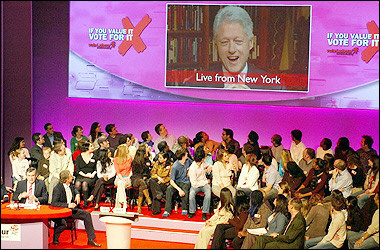 Britain's Prime Minister Tony Blair (bottom 2nd L) and Chancellor of the Exchequer, Gordon Brown (bottom L) listen as former US President Bill Clinton speaks via satellite link at a Labour party election rally at London's Old Vic Theatre.(AFP