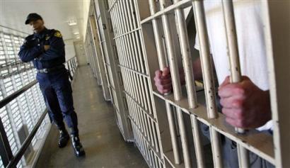 Washington state prisons Lt. Clan Jacobs walks through a block of cells at the Washington Corrections Center in Shelton, Wash. in this Feb. 2, 2005 file photo. Nationwide, U.S. prisons and jails added nearly 1,000 inmates a week in the last year, according to a Bureau of Justice Statistics report. (AP Photo/Ted S. Warren, File)