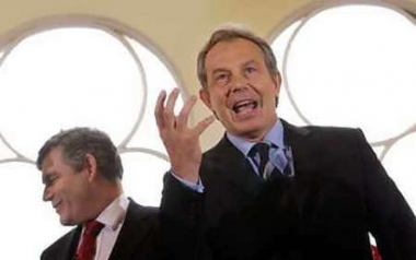 Britain's Prime Minister Tony Blair (R) gestures as Chancellor of the Exchequer Gordon Brown looks away during a joint address to Labour party members and supporters at the Trust Centre in Gloucester, England May 3, 2005. Blair and his opponents fanned out across Britain in a furious campaign finale on Tuesday as polls put the prime minister on track for a third straight term in power despite taking more heavy flak over Iraq. Photo by Pool/Reuters