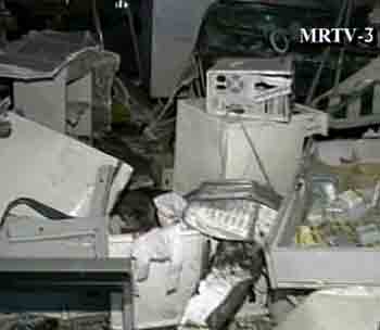 An office damaged by a bomb blast is seen in this image taken from television footage in Yangon May 7, 2005. Three bomb blasts rocked the capital of Myanmar on Saturday, killing 11 people and wounding 162 others. [Reuters]