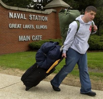 Seaman Brian Bitar, 19, from Miami, Fla., looks for a cab outside the main gate of Great Lakes Naval Station after completing basic training and hospital corpsman school in Great Lakes, Ill., Friday, May 13, 2005. Illinois would lose nearly 2,700 military and civilian jobs under base closures recommended Friday by Defense Secretary Donald Rumsfeld, but the state's major military installations would remain open. The Great Lakes Naval Recruit Training Command in North Chicago is slated to lose 2,022 jobs. (AP