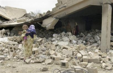 Neighbours inspect houses destroyed during fighting in Rommana village near Qaim, about 320 kilometers (200 miles) northwest of Baghdad in Iraq Sunday, May 15, 2005.