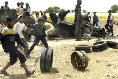 Iraqi children play by a destroyed armoured vehicle near Rommana village near Qaim, about 320 kilometers (200 miles) northwest of Baghdad in Iraq Sunday, May 15, 2005. U.S. forces have been engaged in operation Matador in the area, one of the largest U.S. campaigns since militants were driven out of their Fallujah stronghold in November. (AP