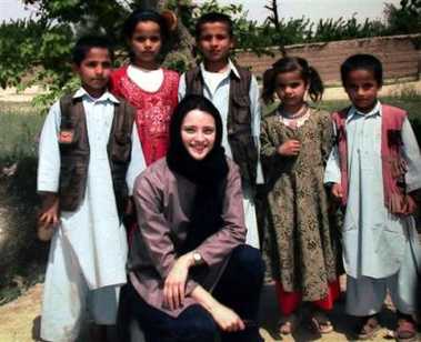 A recent but undated photo of Clementina Cantoni, 32, front centre, posing for the photographer with some Afghan children in an unknown place in Afghanistan. Cantoni, an Italian aid worker working for CARE International, was kidnapped by four armed men in Kabul Monday, May 16, 2005. (AP