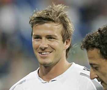 Real Madrids English player David Beckham smiles next to reserve goalkeeper Cesar Sanchez before a Spanish league soccer derby match at the Bernanbeu stadium in Madrid Saturday May 21, 2005.