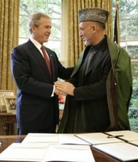 This photo 
 provided 
 by the White House shows President Bush shaking hands with Afghanistan President Hamid Karzai in the Oval Office of the White House Monday, May 23, 2005 after signing a joint declaration that commits both the U.S. and Afghanistan to closely work together to enhance Afghanistan's long-term democracy, prosperity and security. [AP]