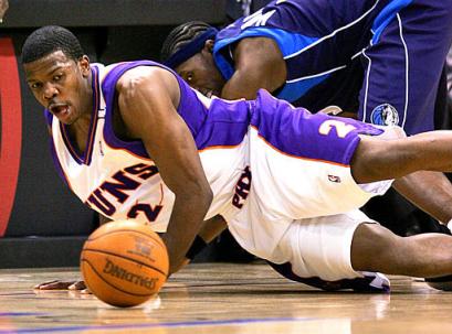 Phoenix Suns' Joe Johnson, front, knocks the ball away from Dallas Mavericks' Josh Howard during the first quarter of a Western Conference semifinal game Monday, May 9, 2005, in Phoenix. (AP 