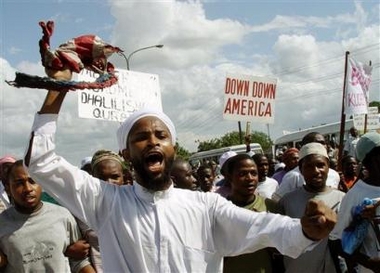 Tanzanian Muslim protesters chant anti US slogans while holding placards ' Down With America' during a demonstration in Dar es Salaam, Tanzania Friday June 3, 2005, protesting against US soldiers who were alleged to have desecrated copies of the islamic holy Quran at Guantanamo Bay in Cuba, a news story later retracted by its source. (AP