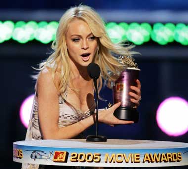 Actress Lindsay Lohan holds her award after winning the Best Female Performance award for her role in the film "Mean Girls" at the 2005 MTV Movie Awards in Los Angeles June 4, 2005. 