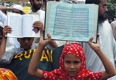 Members of Bangladesh Soldiers of Islam, the children wing of Youth Jamiyat, hold the Quran during an anti-U.S. protest in Dhaka, Bangladesh, Friday, June 3, 2005. The group was demonstrating against the alleged desecration of the Quran by U.S. soldiers in Guantanamo Bay. (AP