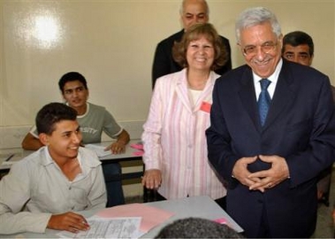 In this photo released by the Palestinian Authority, Palestinian Authority President Mahmoud Abbas, also known as Abu Mazen, right, visits a high school in Gaza City Thursday June 9, 2005. Abbas was also meeting militant groups in Gaza in an effort to resolve domestic political disputes and keep a shaky truce with Israel alive. Israel and the Palestinians are trying to keep the truce intact to allow them to coordinate the Gaza pullout, scheduled to begin in mid-August. (AP