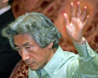 Japanese Prime Minister Junichiro Koizumi raises his hand to answer questions regarding his visit to the controversial Yasukuni Shrine during a Lower House budget committee meeting in Tokyo Thursday, June 2, 2005. A group of former Japanese leaders and the speaker of Parliament's powerful lower house are discouraging Koizumi from making further visits to a war shrine opposed by China. (AP