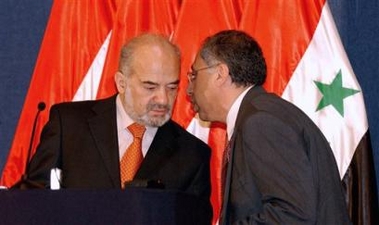 Iraqi Prime Minister Ibrahim al-Jaafari, left, speaks to Iraq's government spokesman Laith Kubba at a press conference Tuesday May 31, 2005 in the heavily fortified Green Zone area in Baghdad, Iraq