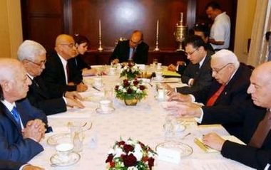 Israel's Prime Minister Ariel Sharon (2nd R) meets Palestinian President Mahmoud Abbas (2nd L) at Sharon's residence in Jerusalem in this picture, released by the Palestinian Authority press office June 21, 2005. 