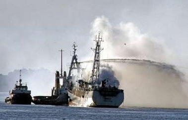 Uruguayan army ships battle to control a fire on a Ukranian fishing vessel, Simeiz, in Montevideo's harbour, June 22, 2005.