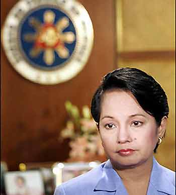 Philippines President Gloria Arroyo looks on before delivering her statement in a live television addressed to the nation at the Malacanang presidential palace, in Manila. Arroyo apologized to the nation after admitting she called an elections commissioner during last year's election but denied rigging the vote
