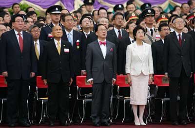 Hong Kong Chief Executive Donald Tsang (C) sings the national anthem beside his wife Salina (2nd R), Hong Kong tycoon Henry Fok (2nd L), head of Beijing's main representative office in Hong Kong Gao Siren (L) and Hong Kong Chief Justice Andrew Li, during a ceremony marking the eighth anniversary of the handover of Hong Kong to Chinese rule July 1, 2005. 