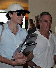 New York City Mayor Michael Bloomberg, right, and his companion Diana Taylor arrive at a convention center for a visit to the venue of the 117th International Olympic Committee session in Singapore Sunday, July 3, 2005. [Reuters]