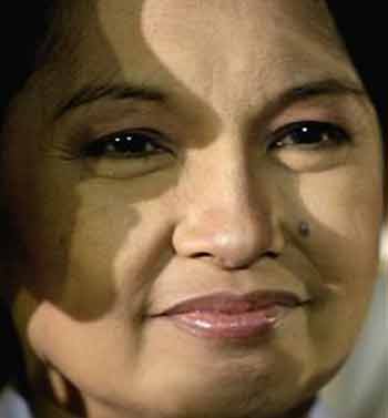 Shadows are cast on the face of Philippine President Gloria Macapagal Arroyo as she attends awarding ceremonies at Malacanang palace in Manila, Philippines, on Thursday, July 7, 2005. 