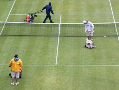 The grounds crew at the International Tennis Hall of Fame work to dry the court after a rain delay Friday, July 8, 2005, at the Campbell's Hall of Fame Tennis Championships, in Newport, R.I. (AP