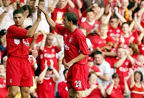 Liverpool's Steven Gerrard (L) celebrates scoring his first goal with Stephen Warnock (R) during their UEFA Champions League first qualifying round, first leg soccer match against Total Network Solutions at Anfield, northern England, July 13, 2005. 
