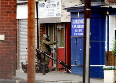 A bomb disposal officer working with a bomb disposal robot opens up a property on Lodge Lane, Beeston, Leeds, northern England, Thursday July 14, 2005. The property is being investigated in connection with the London bombings of last Thursday. (AP