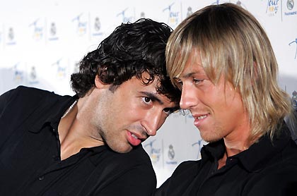 Real Madrid striker Raul (L) talks to midfielder Guti during a news conference in Chicago July 14, 2005. Real Madrid will face Chivas Guadalajara in a friendly match on July 16.