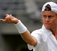 Australia's Lleyton Hewitt gestures towards his opponent, Argentina's Guillermo Coria, during their Davis Cup world group quarter-final singles match in Sydney July 15, 2005. Hewitt defeated Coria 7-6 6-1 1-6 6-2 in the first match of the world group tie, giving Australia a 1-0 lead.