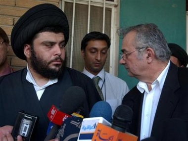 Shiite cleric Moqtada al-Sadr, left, meets with U.N. Special Envoy to Iraq Ashraf Qadhi outside al-Sadr's office in Najaf, Iraq Sunday, July 10, 2005. (AP