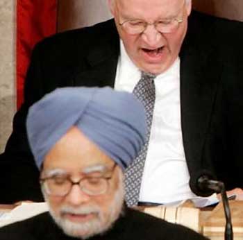 U.S. Vice President Dick Cheney (top) yawns during a speech by India Prime Minister Manmohan Singh (bottom) during a special Joint Meeting of Congress in the U.S. House of Representatives chamber on Capitol Hill, July 19, 2005. India upholds nuclear nonproliferation rules and will never spread sensitive technology, Singh said on Tuesday, a day after the United States promised to help the South Asian power develop its civilian atomic sector. REUTERS