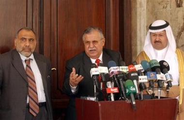 Flanked by Iraqi vice presidents Adel Abed Mahdi, left, and Ghazi al-Yawar, right, Iraqi President Jalal Talabani speaks to media during a press conference at the Presidential Palace Tuesday, July 19, 2005, in Baghdad, Iraq. Talabani predicted Tuesday that Iraq's new constitution could be completed by the end of the month if a deal can be worked out with critics who have reservations about parts of the document. The deadline for completing the draft is Aug. 15, after which the charter will be submitted to the electorate for approval two months later. (AP