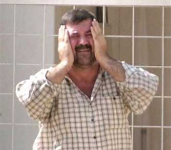 An Iraqi man breaks down outside the hospital emergency ward where casualties of a gunmen attack were brought, Tuesday morning, July 19, 2005, in Baqouba, just 30 kms (18 miles) north of Baghdad, Iraq. 