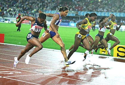 Lauryn Williams of the U.S. (L) crosses the finish line to win the women's 100 metres race ahead of third placed Christine Arron of France (2nd L) and second placed Veronica Campbell of Jamaica (3rd L) at the world athletics championships in Helsinki August 8, 2005. Williams clocked 10.93 seconds to win the gold medal. 