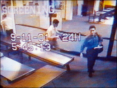 Video image from Portland International Jetport security shows suspected hijackers Mohammed Atta (R) and Abdulaziz Alomari (C) as they pass through airport security 11 September, 2001. A year before the September 11 attacks, Mohammed Atta and three other bombers had been identified as likely members of a cell of the Al-Qaeda operating in the US by a military intelligence team that recommended sharing the information with the FBI, The New York Times said(AFP