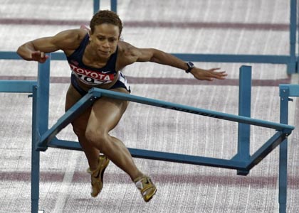 Joanna Hayes of the U.S. crashes into the last hurdle during the women's 100 metres hurdles final at the world athletics championships in Helsinki August 11, 2005.