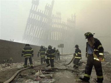 Firefighters work beneath the destroyed World Trade Center's twin towers after a terrorist attack in New York on Sept. 11, 2001. (AP