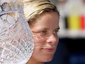 Belgium's Kim Clijsters poses with the championship trophy in front of a Belgian flag in the crowd after defeating Daniela Hantuchova of Slovakia in the final of the Los Angeles Open WTA tournament in Carson, California, August 14, 2005. 