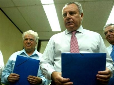 Greek Justice Minister Anastasios Papaligouras, right, and chief Athens Coroner Fillipos Koutsaftis, left, hold envelopes with the toxicological tests of six people who were aboard the Cyprus Helios Boeing 737-300 that crashed into a mountainside Sunday, killing all 121 people on board, in Athens on Friday, Aug. 19, 2005.