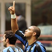 Inter Milan's Adriano (R) celebrates with his team mate Luis Figo after scoring against Treviso during their Serie A soccer match at the San Siro Stadium in Milan August 28, 2005. 